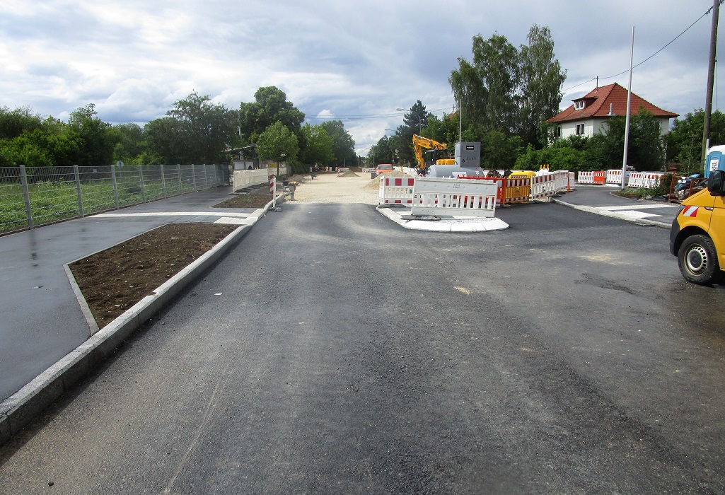 Neubau der Straße mit Bagger im Hintergrund